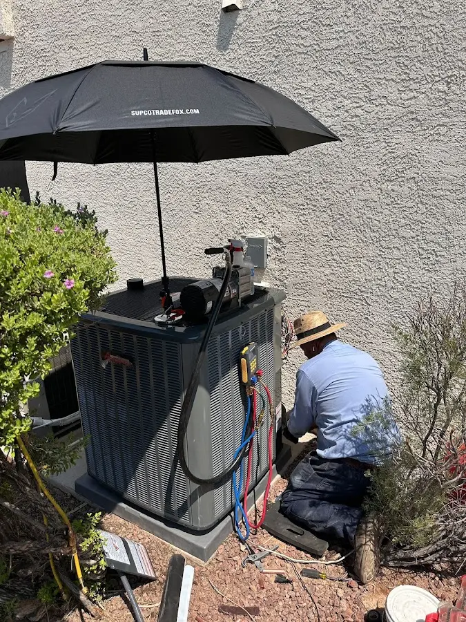 HVAC technician performing outdoor AC maintenance in Fox Crossing