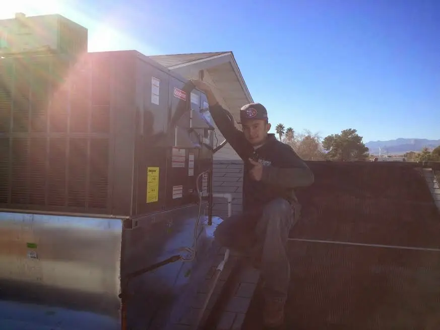 HVAC technician performing Boiler Repair on a rooftop unit in Fox Crossing